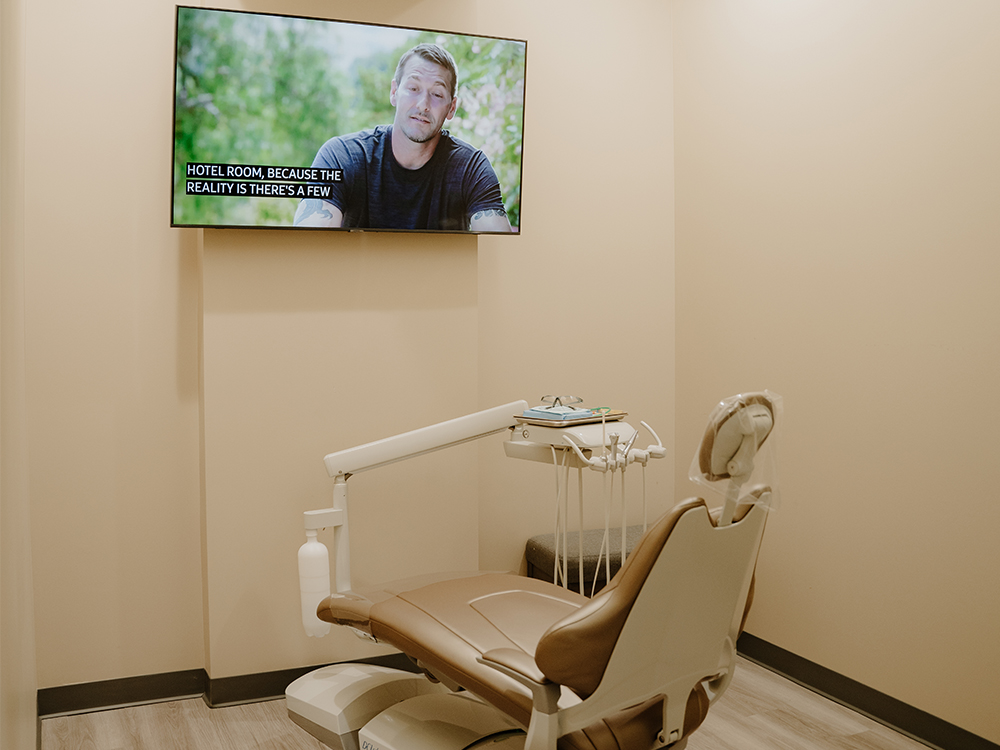 Photo of a patient room with a TV at Perimeter Dental's Midtown location.